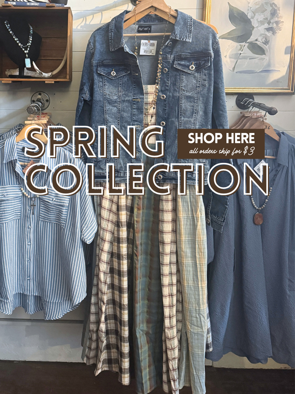 Spring collection display with denim jacket, plaid dress, and striped shirt in a store setting.