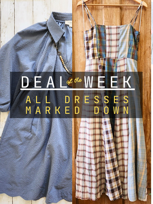 Two dresses hanging on a wooden rack with text overlay 'Deal of the Week: All Dresses Marked Down'.