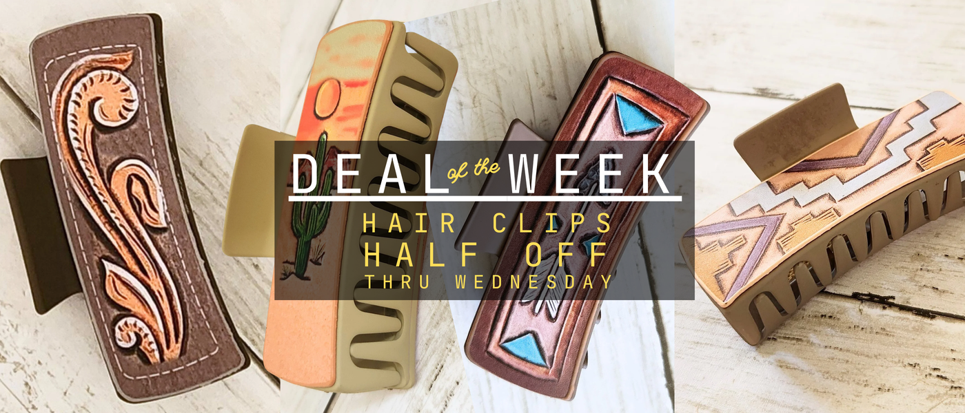 Four decorative hair clips arranged on a whitewashed wood surface with a central promotional banner reading 'DEAL of the WEEK HAIR CLIPS HALF OFF THRU WEDNESDAY.' The clips include brown leather with tan paisley detailing, tan and brown with a cactus motif, reddish-brown with blue geometric accents, and tan with pink geometric accents.